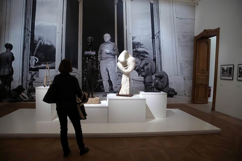 Visitors examine the artworks in the Picasso National Museum